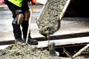 concrete-pouring-mixer-spreading-worker-rake-hard-boots-knee-protector-concrete-pouring-mixer-327561471